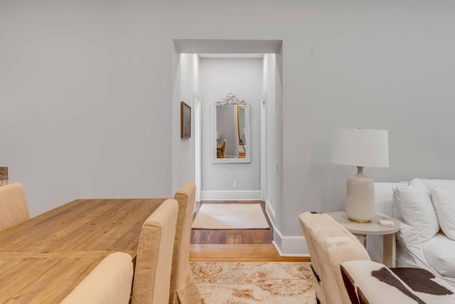 interior space featuring light wood-type flooring and baseboards