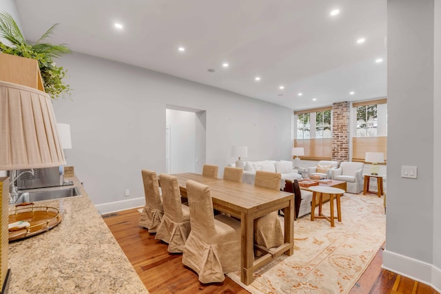 dining room with light wood-type flooring, baseboards, visible vents, and recessed lighting