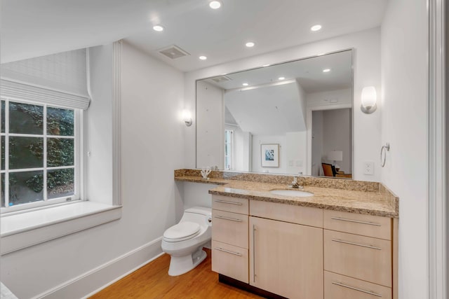 bathroom with recessed lighting, visible vents, toilet, wood finished floors, and baseboards