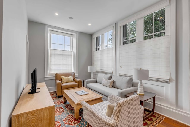 living room with recessed lighting, baseboards, and wood finished floors