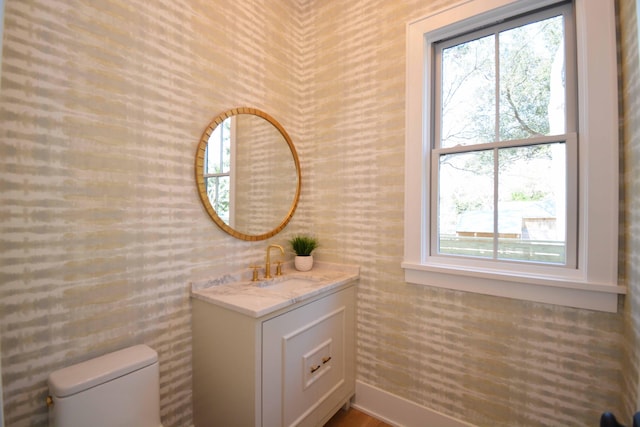 half bath featuring toilet and vanity