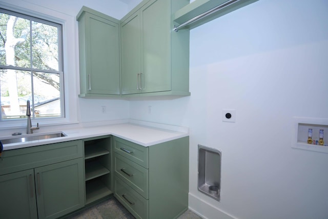 clothes washing area featuring a sink, hookup for a washing machine, cabinet space, and electric dryer hookup