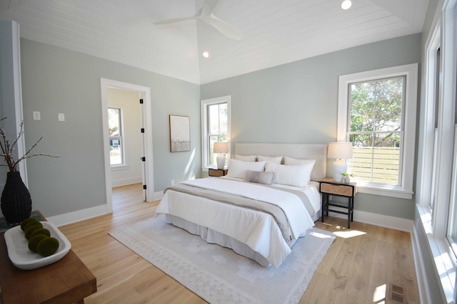 bedroom with recessed lighting, light wood-style flooring, baseboards, and vaulted ceiling