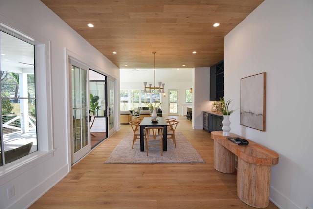 dining space featuring wooden ceiling, light wood-style flooring, and plenty of natural light