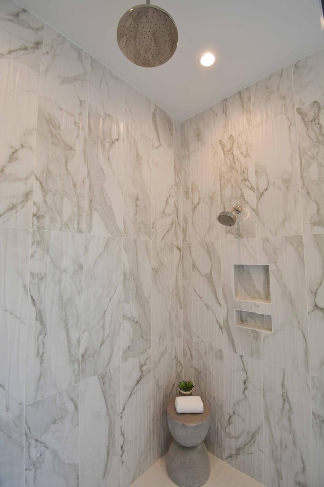 full bathroom with a tile shower and recessed lighting