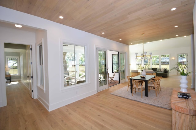 dining space with recessed lighting, light wood-style flooring, wood ceiling, and a healthy amount of sunlight