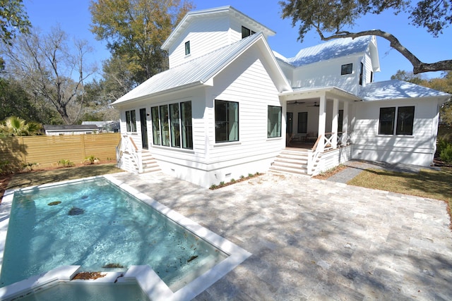 rear view of property with metal roof, a patio area, a ceiling fan, and fence