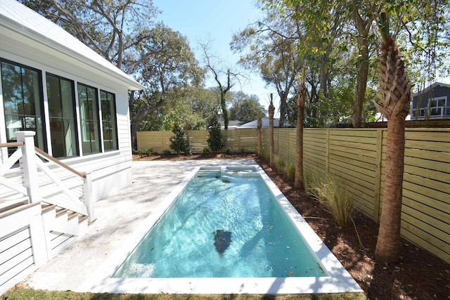 view of pool featuring a patio and a fenced backyard