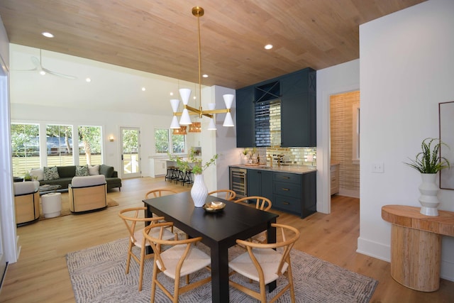 dining room featuring recessed lighting, wine cooler, light wood finished floors, baseboards, and wood ceiling