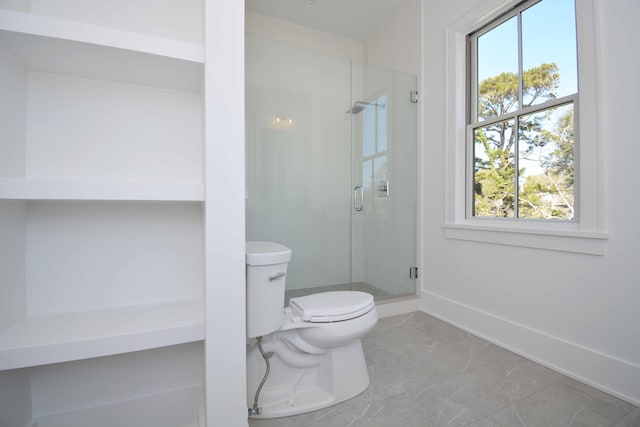 bathroom featuring toilet, baseboards, a stall shower, and marble finish floor