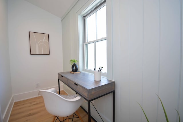 office space featuring baseboards and light wood-type flooring