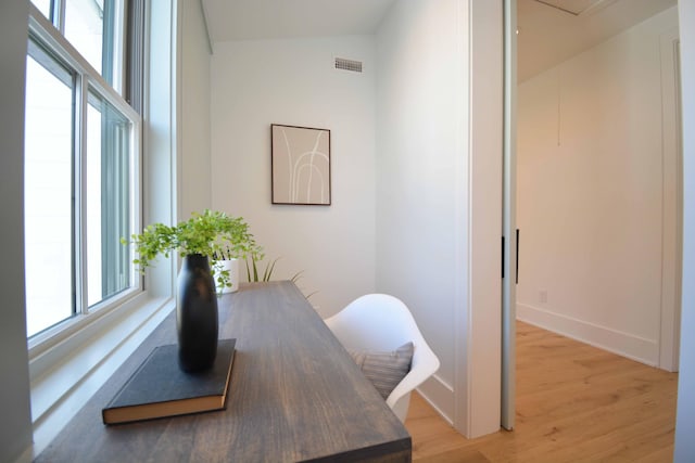 office featuring visible vents, light wood-type flooring, and baseboards