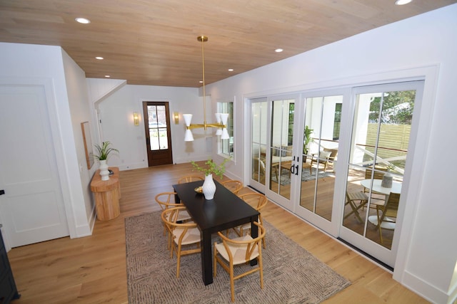 dining space with a notable chandelier, recessed lighting, light wood-style floors, and a wealth of natural light