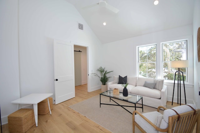 living area with visible vents, light wood finished floors, high vaulted ceiling, baseboards, and recessed lighting