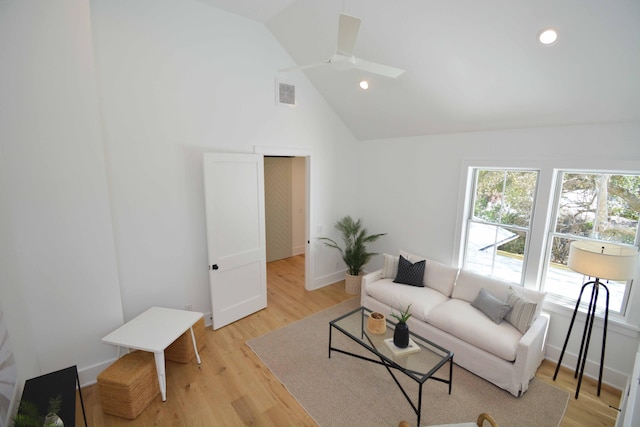 living area with visible vents, baseboards, recessed lighting, light wood-style flooring, and high vaulted ceiling