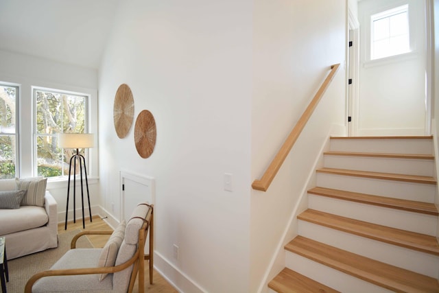 stairs with baseboards and wood finished floors