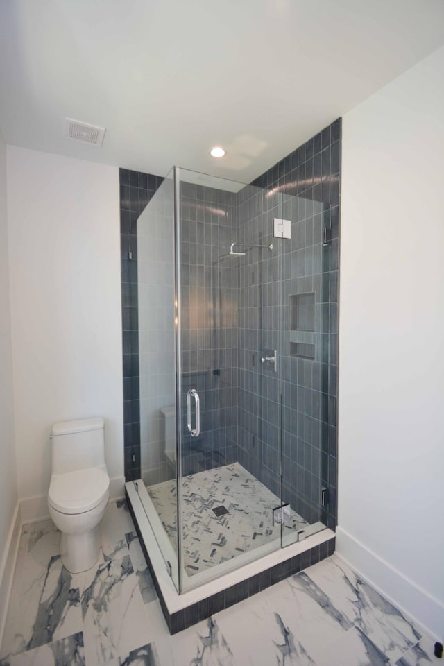 bathroom featuring visible vents, baseboards, toilet, and marble finish floor