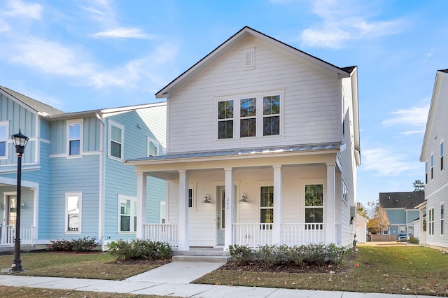 view of front of house featuring covered porch and a front lawn