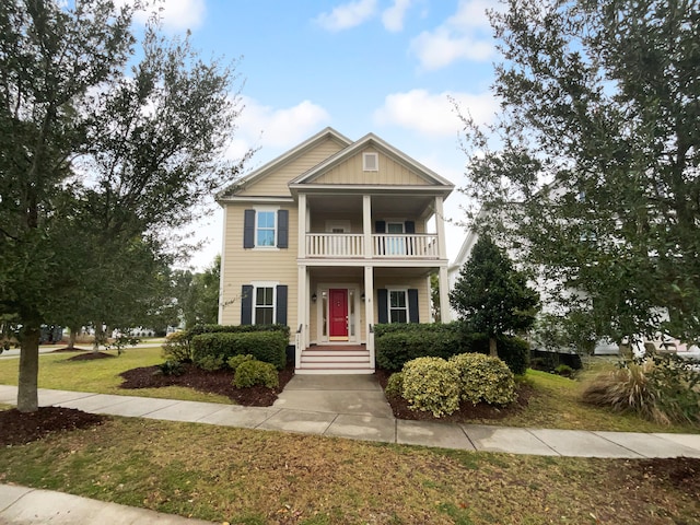 view of front of home featuring a balcony and a front lawn