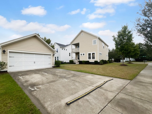 view of front of home featuring a balcony, a garage, and a front lawn