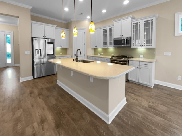 kitchen with appliances with stainless steel finishes, white cabinetry, dark hardwood / wood-style flooring, pendant lighting, and sink