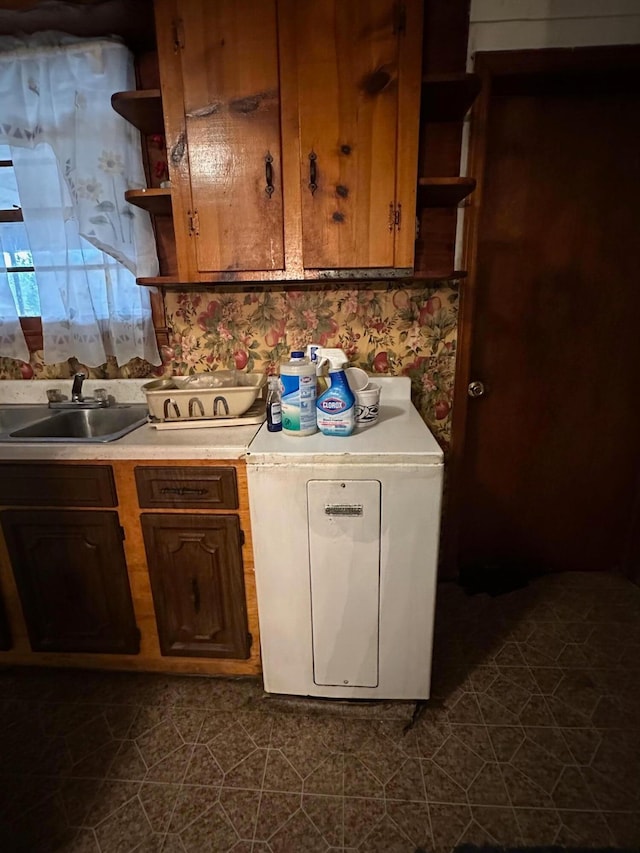 kitchen featuring dark tile floors and sink