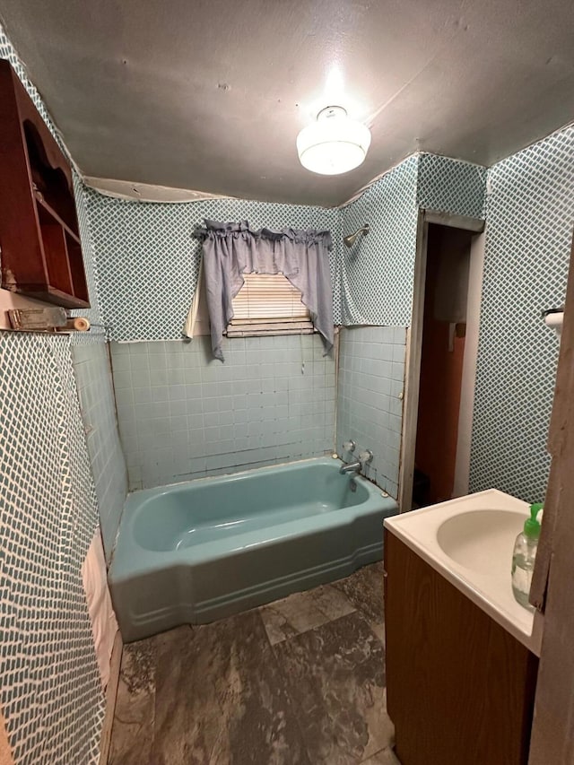 bathroom featuring tiled shower / bath combo, tile floors, and vanity