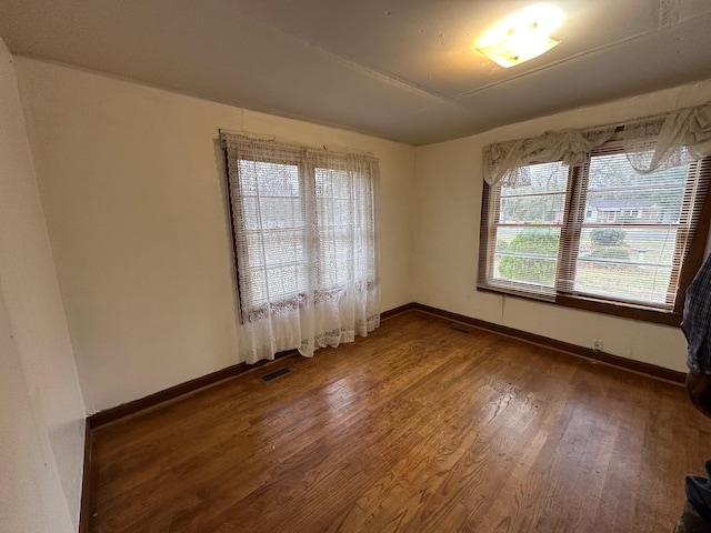 unfurnished room featuring dark wood-type flooring