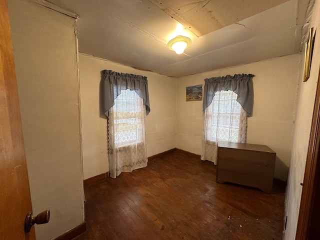 unfurnished room featuring dark hardwood / wood-style flooring