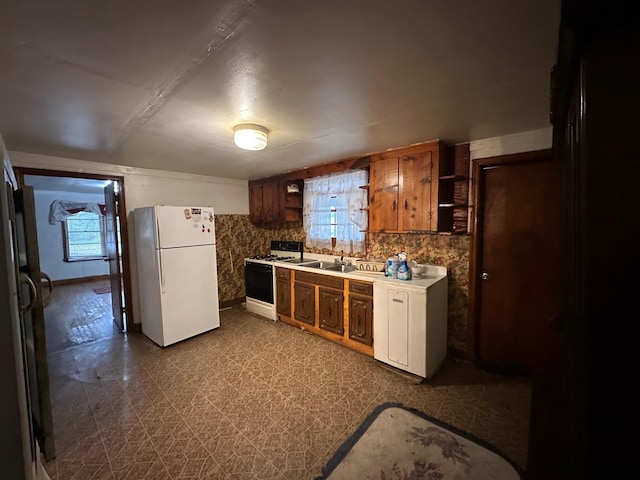 kitchen featuring sink, white appliances, backsplash, and dark tile floors