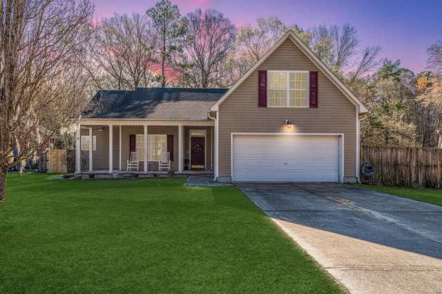 front facade with a porch, a garage, and a yard