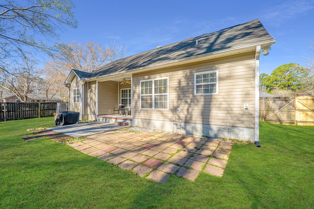 rear view of house with a patio area and a yard