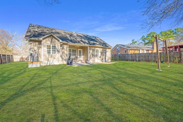 back of house featuring a yard and a patio area