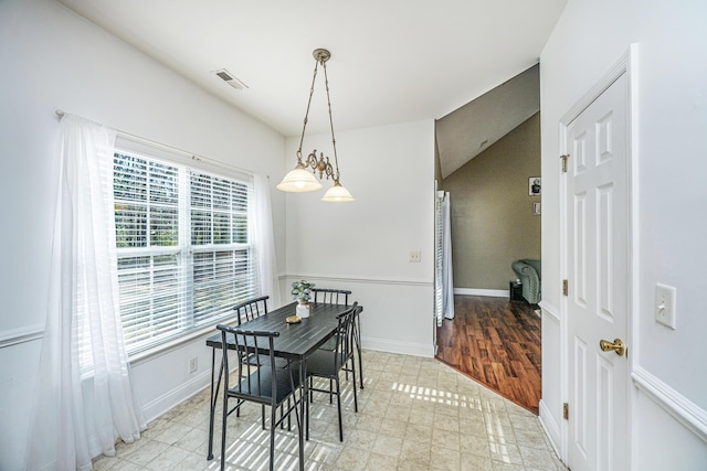 dining room featuring vaulted ceiling