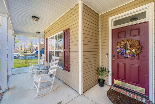 view of exterior entry featuring a porch