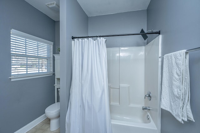 bathroom with toilet and shower / bath combo