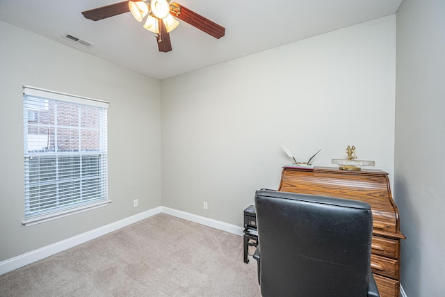 carpeted office featuring ceiling fan