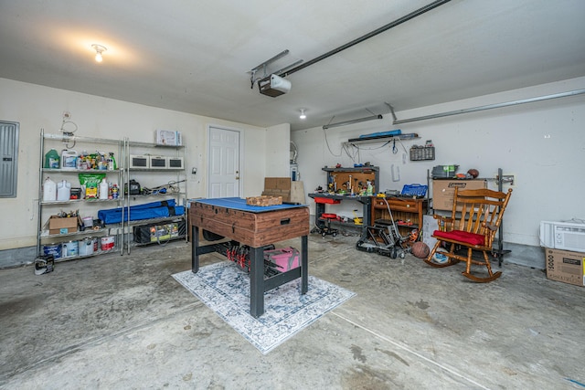 garage with electric panel, a garage door opener, and a workshop area