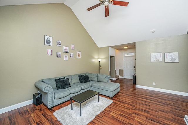 living room featuring dark hardwood / wood-style flooring, high vaulted ceiling, and ceiling fan