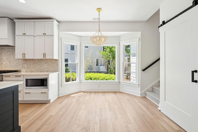 380 Tidal Reef Cir, Mount Pleasant, SC 29464 - kitchen with built in microwave, light countertops, light wood-style floors, premium range hood, and recessed lighting