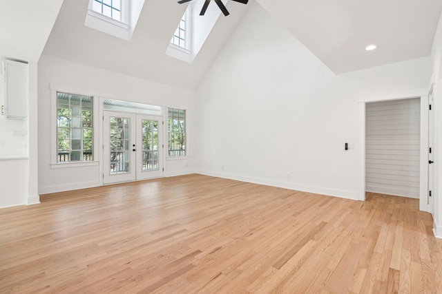 380 Tidal Reef Cir, Mount Pleasant, SC 29464 - unfurnished living room featuring high vaulted ceiling, a skylight, ceiling fan, healthy amount of natural light, and light wood-style floors