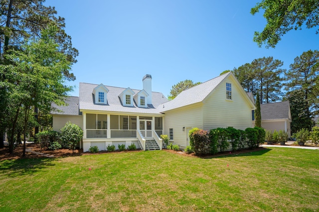 380 Tidal Reef Cir, Mount Pleasant, SC 29464 - rear view of property with a sunroom, a lawn, and a chimney