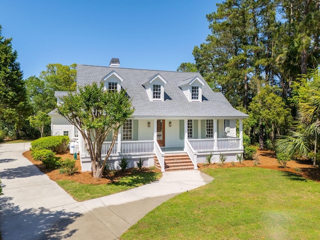 380 Tidal Reef Cir, Mount Pleasant, SC 29464 - cape cod-style house with covered porch, roof with shingles, a front lawn, a chimney, and concrete driveway