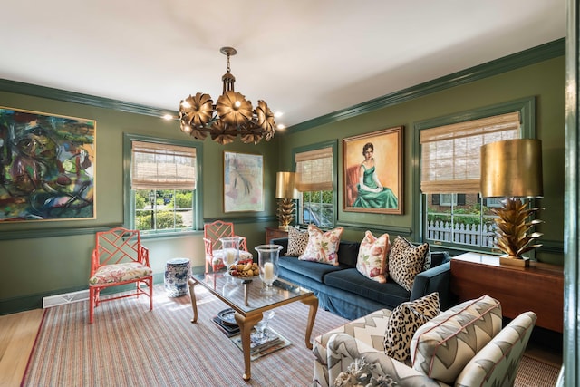 living room with ornamental molding, wood finished floors, a notable chandelier, and a healthy amount of sunlight