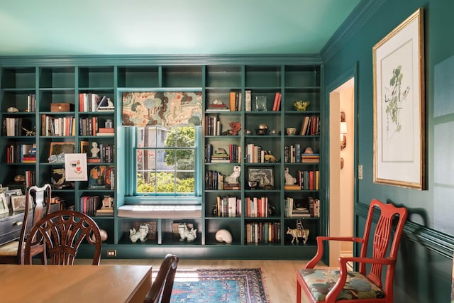 sitting room with crown molding and wood finished floors