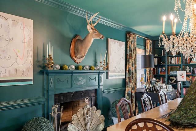 dining area featuring crown molding and a high end fireplace