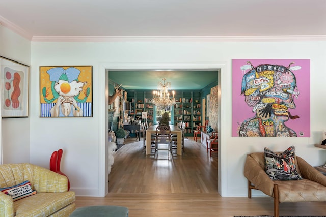 dining area with baseboards, a chandelier, ornamental molding, and wood finished floors