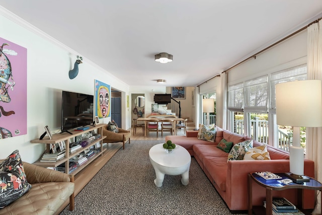 living room with wood finished floors and stairway