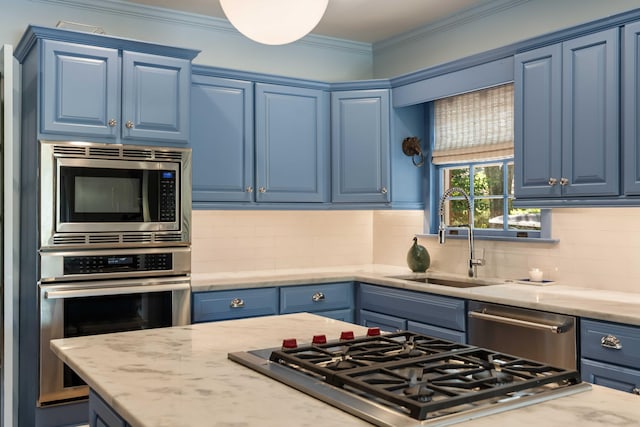 kitchen with decorative backsplash, blue cabinets, light stone countertops, a sink, and stainless steel appliances