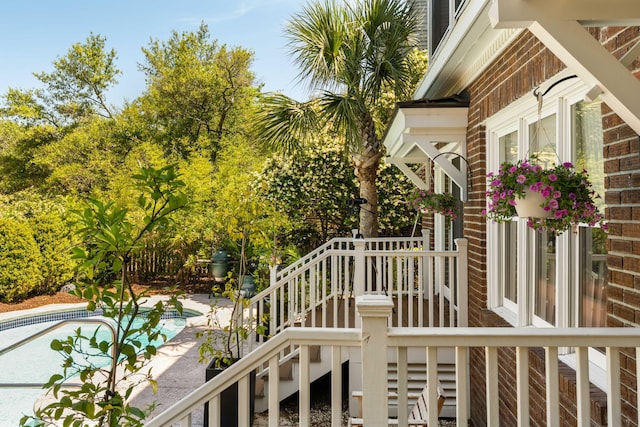 wooden terrace with an outdoor pool